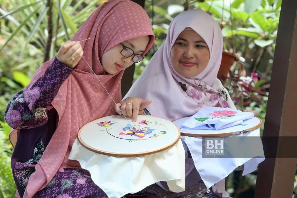 Anis Humairah Binti Riduwan working on her embroidery.