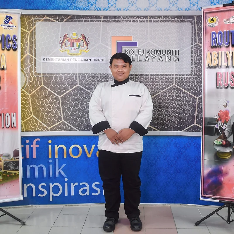 Malaysian competitor preparing dishes during culinary skills training.