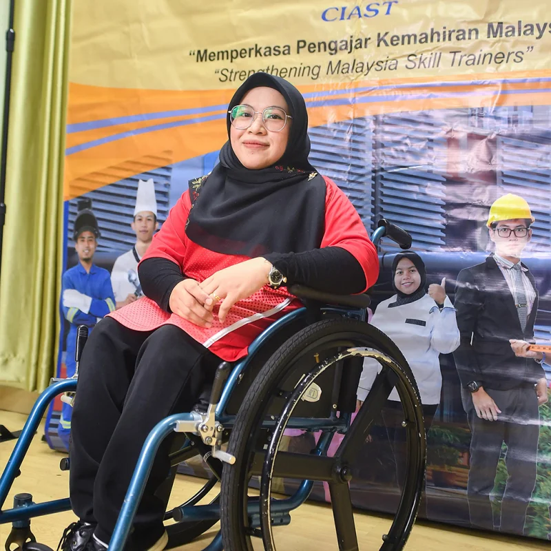 Malaysian competitor working on web design at Abilympics.